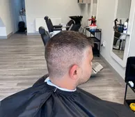 A textured crop with a mid skin fade, from behind