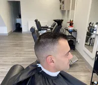 A high skin fade on a short crop, seen from the side